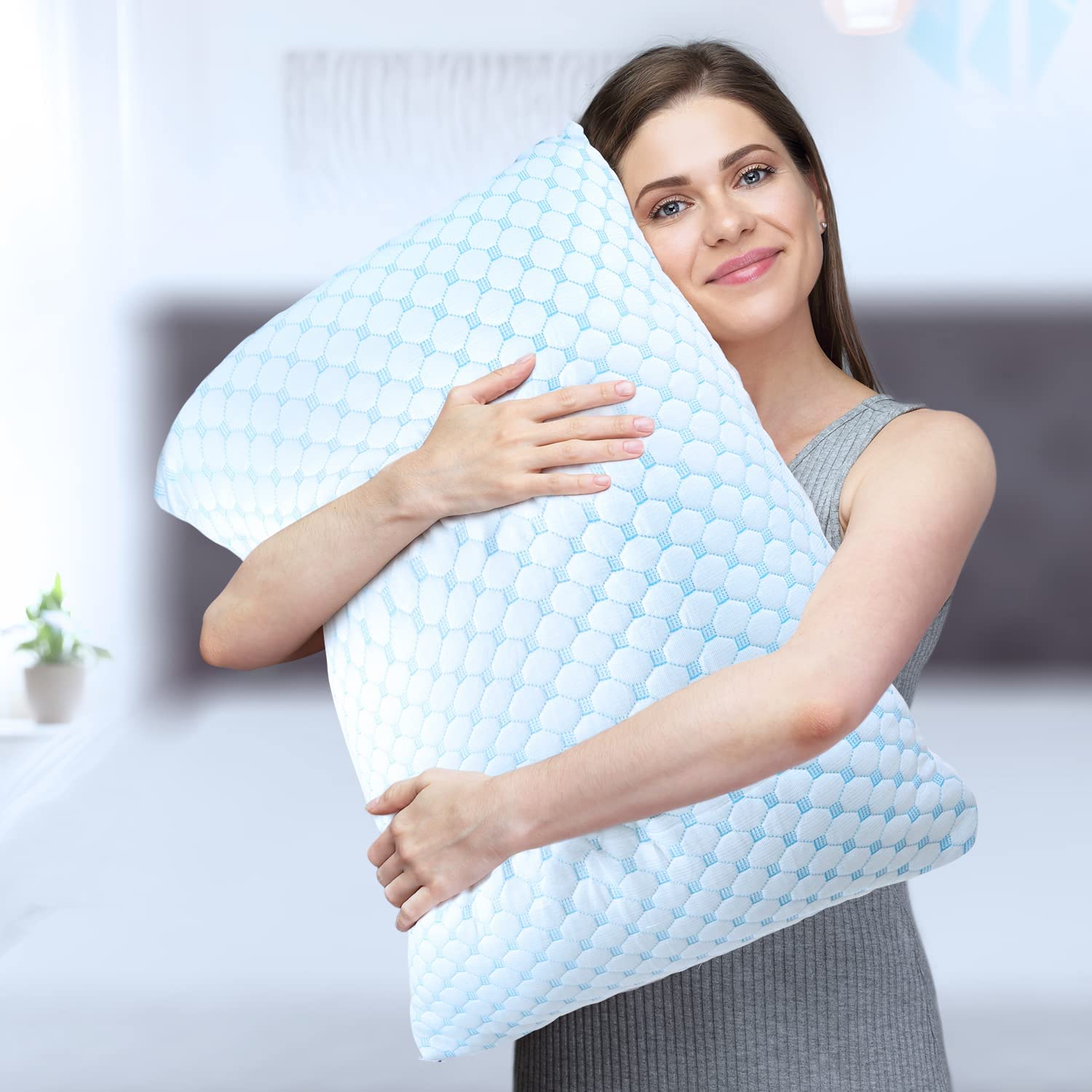 A woman holding a Livingful Premium Cooling Bed Pillow in her arms.