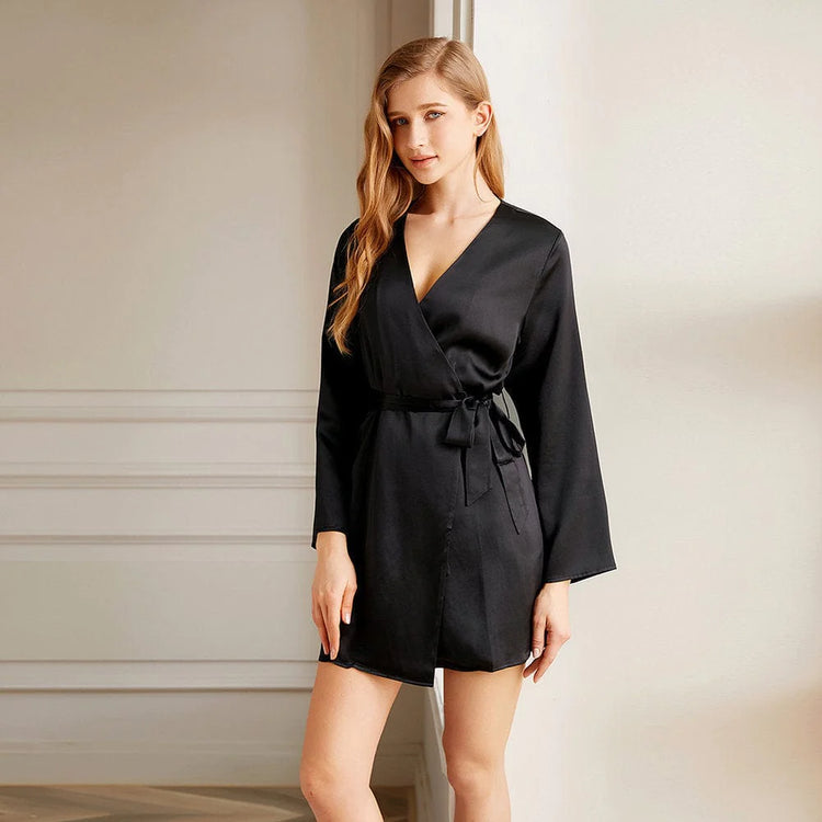 A woman wearing a Livingful Premium Silk Short Bathrobe standing in front of a door.